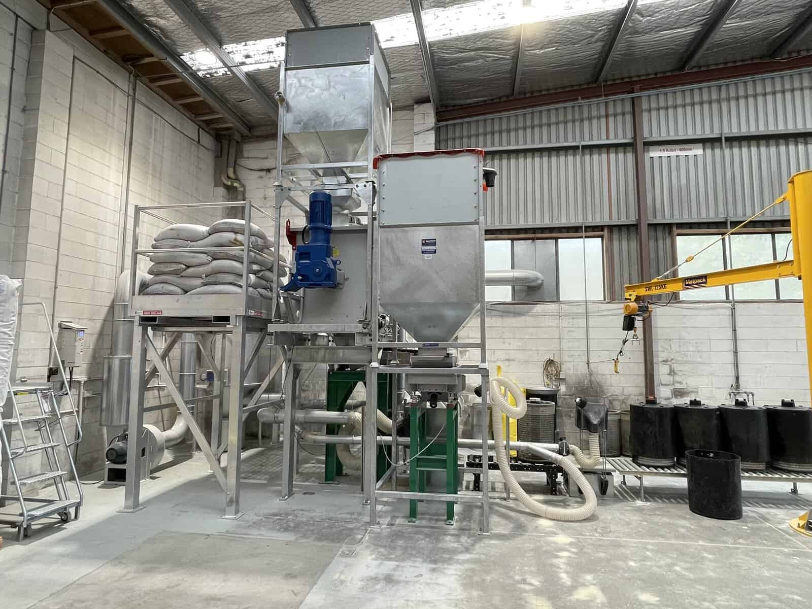 Integrated Stormwater360 cartridge loading plant showing hoppers, feeders and extraction ducting