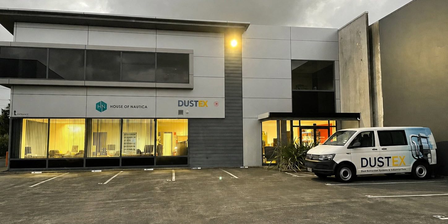 Dustex NZ building with company logo and vehicle in parking lot.